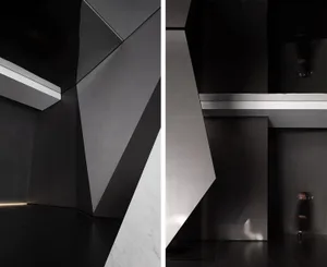 Modern black interior design featuring concrete walls and geometric shapes.