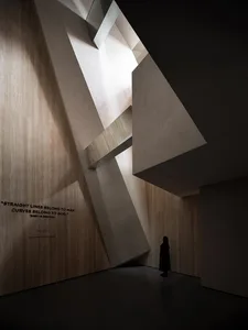 A modern architectural interior with a contemporary design featuring concrete elements and natural light.