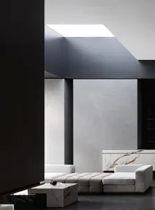 Contemporary living room featuring marble, concrete, and leather materials.