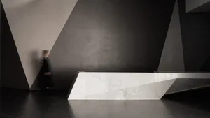 A minimalist interior featuring a marble counter and concrete walls