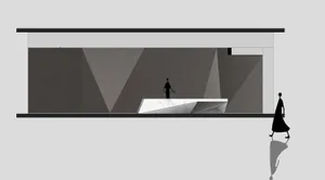Modern office space with a reception desk, grey walls, and a woman walking by.