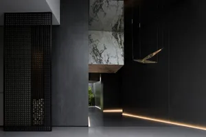 A modern interior design featuring concrete walls with embedded lighting and a minimalist spatial composition.