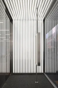 A modern interior space featuring metallic columns and vertical lines.