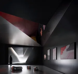 A modern interior design of a lobby with concrete walls and a high ceiling.