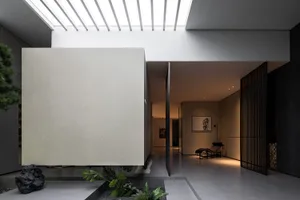 Modern minimalist interior with concrete walls and glass elements