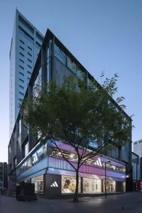 Modern retail storefront with glass exterior and illuminated signage
