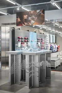 Shoe display in a retail store with metal and glass structures.