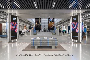 Modern retail store interior featuring steel, concrete, and glass materials.
