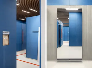 An interior office space featuring minimalist design and blue walls.
