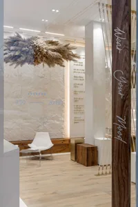 A retail storefront featuring concrete walls and handmade architectural features.