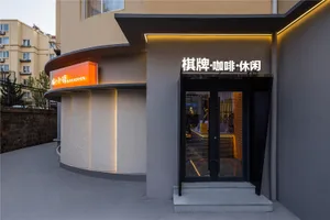 A modern restaurant exterior featuring a minimalist design with concrete materials.