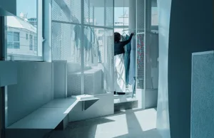 A modern interior space with glass walls and a minimalist design.