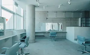 A sleek modern office space with minimalist design features, showcasing clean lines and concrete materials.