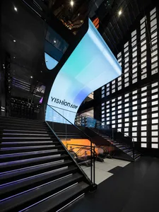Modern staircase with metallic steps and glass railings