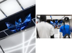 Modern retail space with blue metallic geometric shapes hanging from the ceiling.