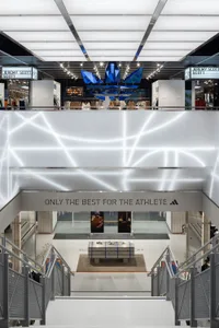 A modern retail storefront with blue acrylic shapes hanging from the ceiling.