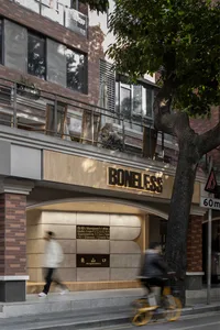 A retail storefront with a brick exterior and wooden and metallic accents.