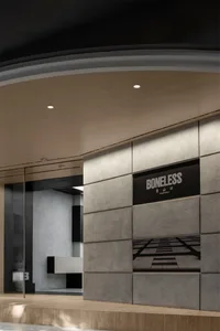 The storefront of a minimalist retail store with industrial-style concrete and geometric design features.