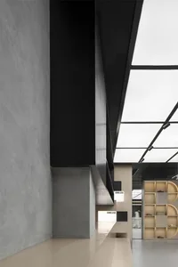 Modern indoor space featuring concrete walls and floor, with a minimalist design.