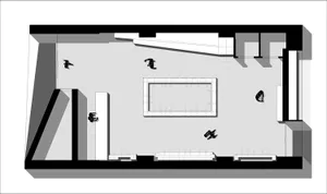 A minimalist office space featuring concrete and glass materials, depicted in a floor plan layout.