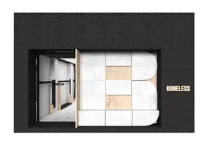 A minimalist retail storefront with a concrete facade, featuring the word 'BONELESS' in wooden letters.