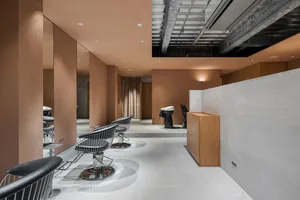 Modern minimalist commercial interior with concrete walls and floors, featuring sleek furniture and industrial design element