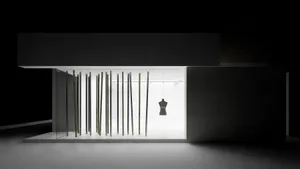 A minimalist exhibition space featuring glass and metal materials.