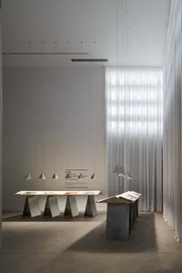 Minimalist exhibition space featuring geometric design elements and modern lighting.