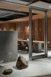 Minimalist restaurant interior featuring wood and concrete materials