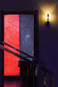 A modern interior space illuminated by an elegant light fixture.
