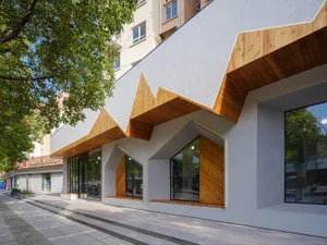 A modern storefront with a combination of wood and concrete materials.