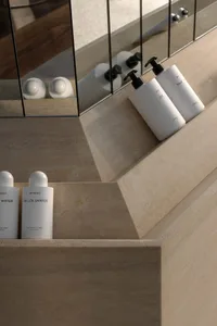 White bottles with black caps on a marble sink