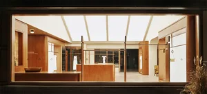 Minimalist storefront with wooden elements and glass display cases