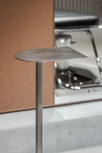 Modern industrial bar stool with a metallic surface and sleek design.