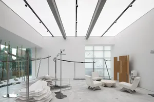 A modern interior design featuring metallic furniture and installations