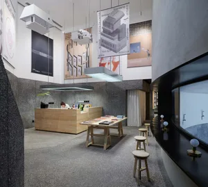 A modern library with books displayed on shelves, a counter with books and documents, and stools and tables.