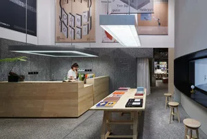 A modern library/cafe interior featuring a wooden camera desk.