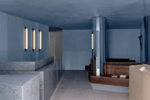 Modern concrete lobby with minimalist design and sleek lighting fixtures.