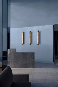 A modern minimalist lobby with concrete walls and lighting fixtures.