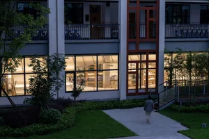 A modern retail storefront with glass walls and marble accents.