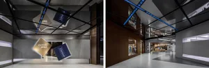 Modern shopping mall interior with concrete tiles walls and floor, blue lighting, and geometric ceiling design