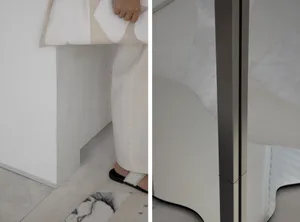 A minimalist interior design featuring a glass panel, representing modern and sleek aesthetics.