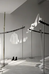 Modern retail shop featuring a minimalist metal clothing rack.
