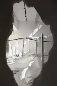 A minimalist retail space featuring paper installation art.