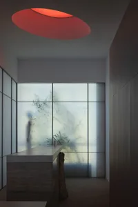 A minimalist interior design featuring a glass curtain wall, showcasing contemporary design elements.