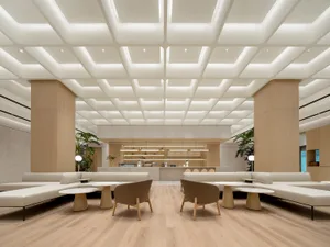 Modern minimalist coffee shop featuring marble and wooden elements.
