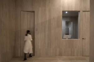 A minimalist office interior with marble walls and flooring.