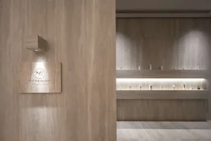 A minimalistic retail shop featuring concrete interiors and signage.