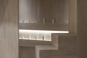 Modern minimalist retail store interior with concrete walls and glass displays.