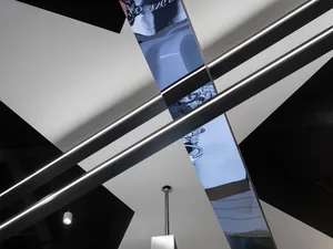 A modern interior design featuring metallic framed glass elements.